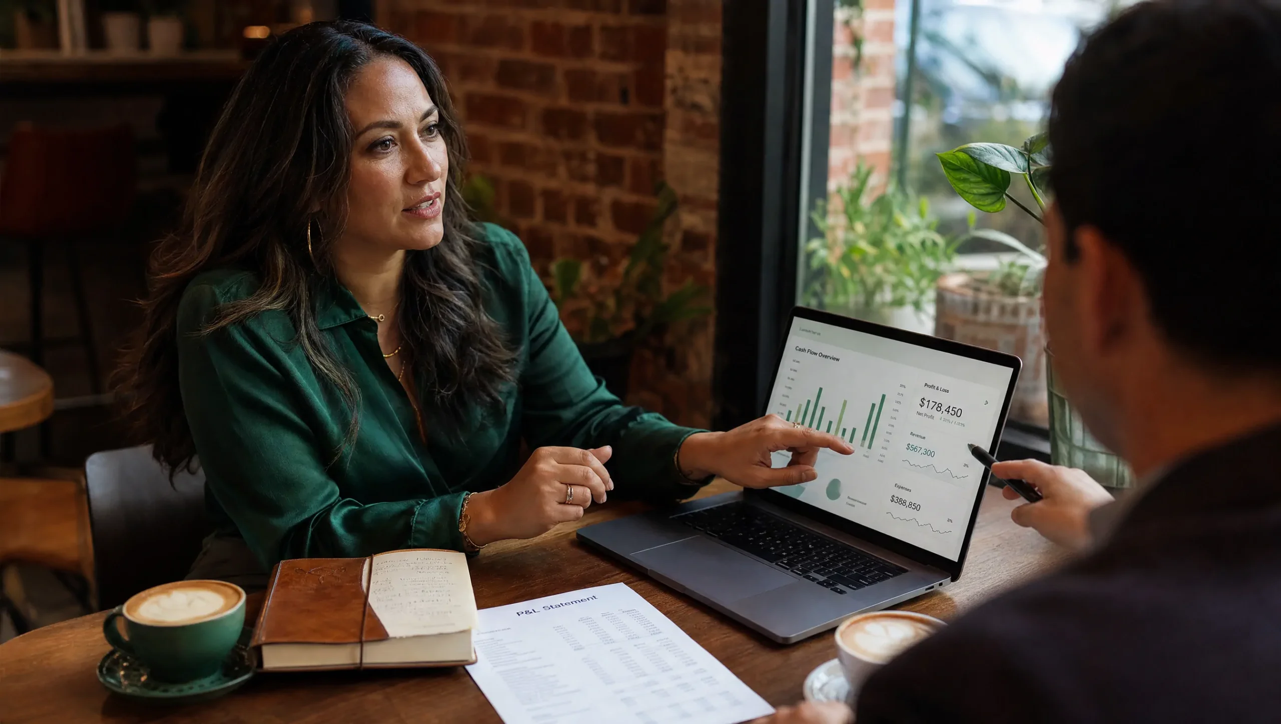 Small business owner in a strategy meeting reviewing financial reports with her SAS CFO advisor